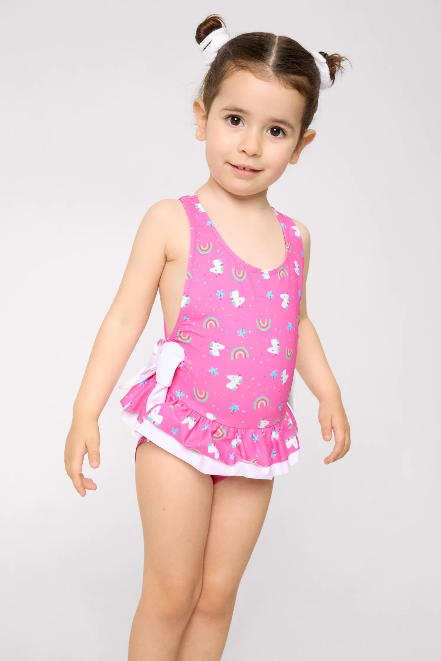 Bañador niña detalles volantes y lazos estampado unicornios rosa