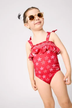 Bañador niña detalle volante estampado estrellas marinas rojo