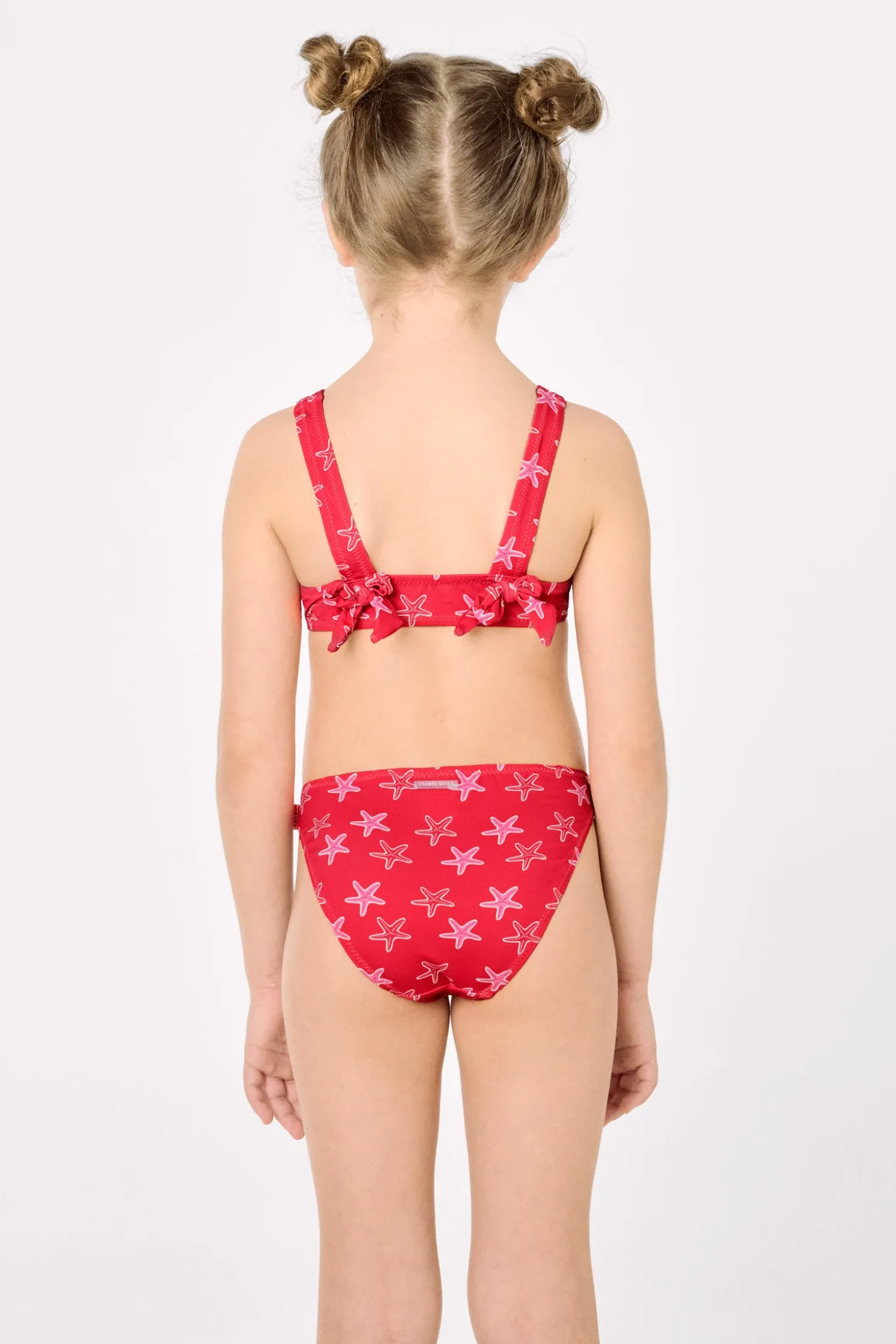 Bikini niña detalles volantes y lazos estampado estrellas marinas rojo