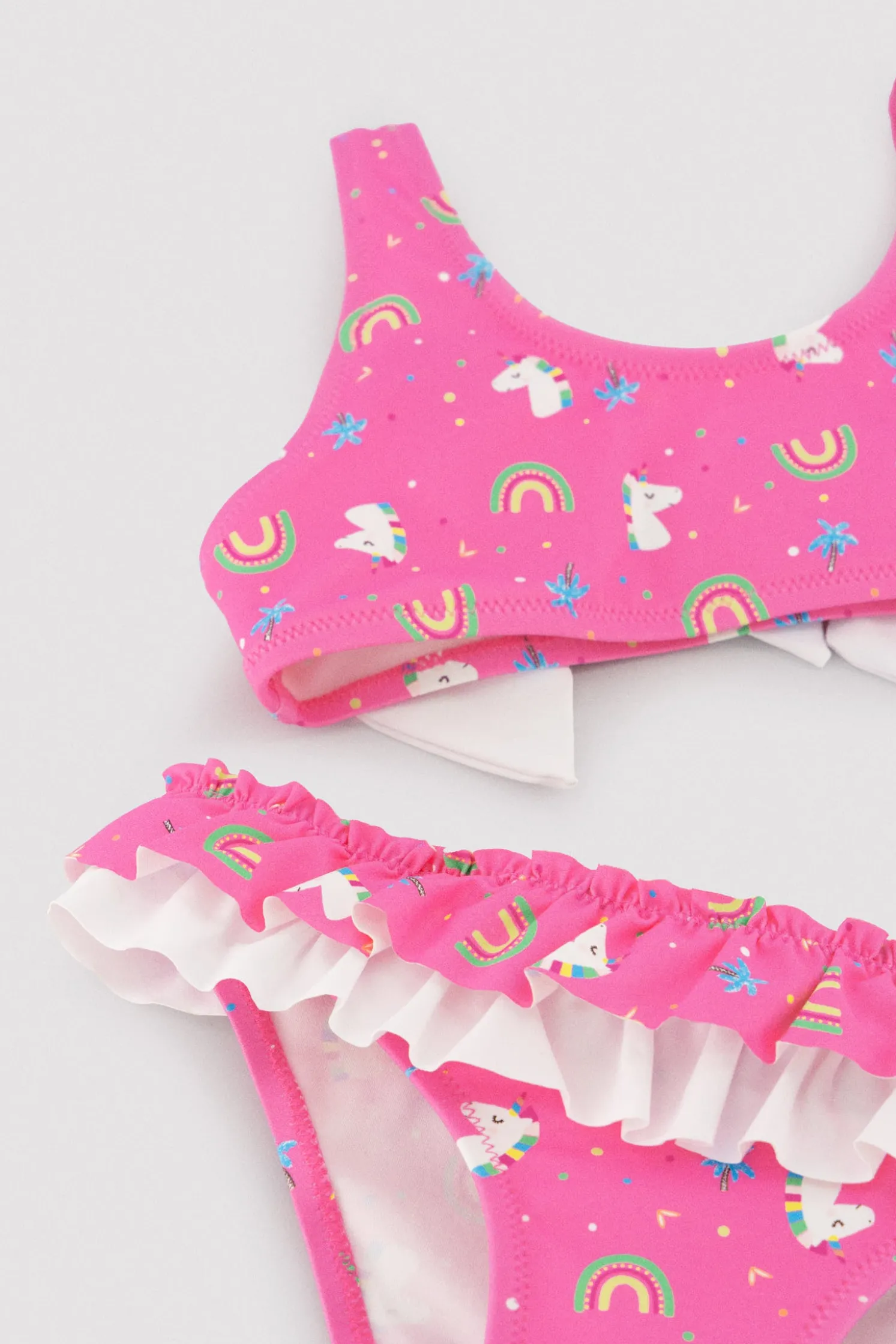 Bikini niña detalle volantes y lazos estampado unicornios rosa