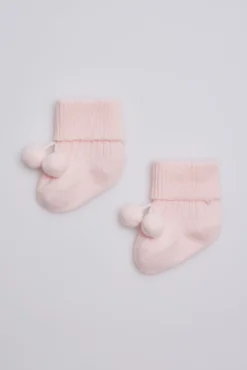 Calcetines canalé con borlas recién nacido rosa