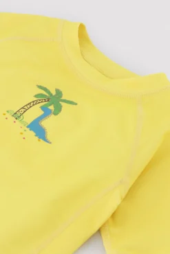 Camiseta de baño bebé dibujo dinosaurio y palmera amarillo