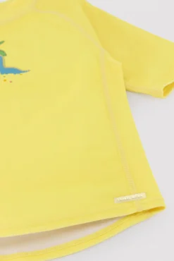 Camiseta de baño bebé dibujo dinosaurio y palmera amarillo