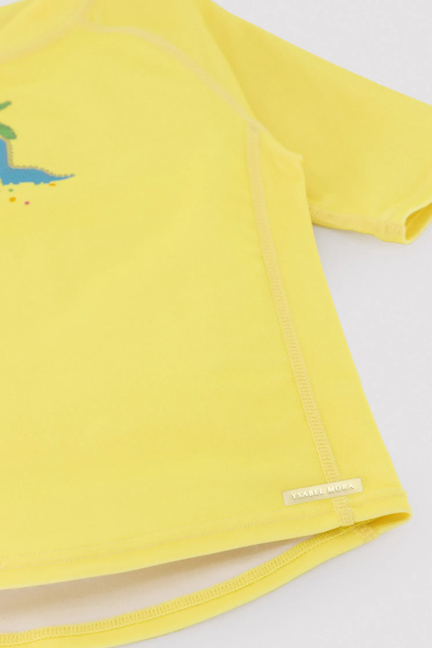 Camiseta de baño bebé dibujo dinosaurio y palmera amarillo