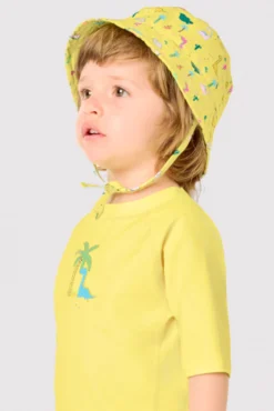 Camiseta de baño bebé dibujo dinosaurio y palmera amarillo