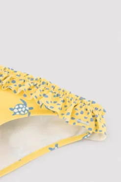 Culetín niña detalle volantes y lazos estampado tortugas amarillo
